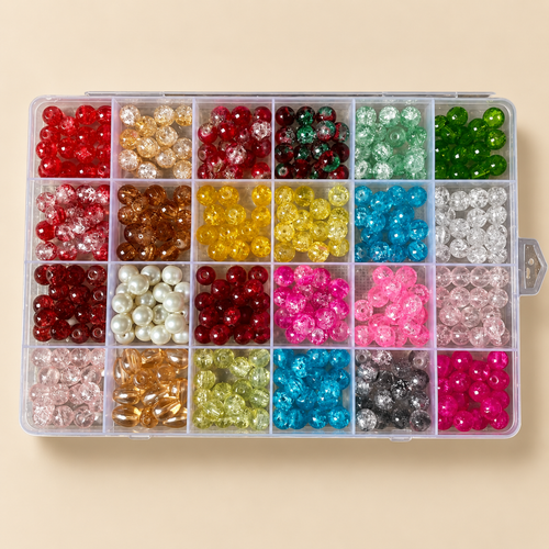 A clear plastic organizer box filled with many small round craft beads in assorted colors, arranged in a grid on a light beige background.